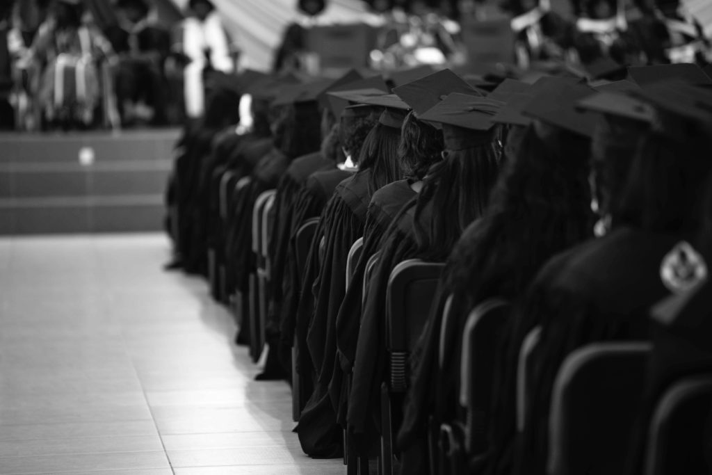 Image of a group of graduating students sitting in chairs. This image shows how life transitions therapy in Austin, TX can help you with your big change into adulthood.