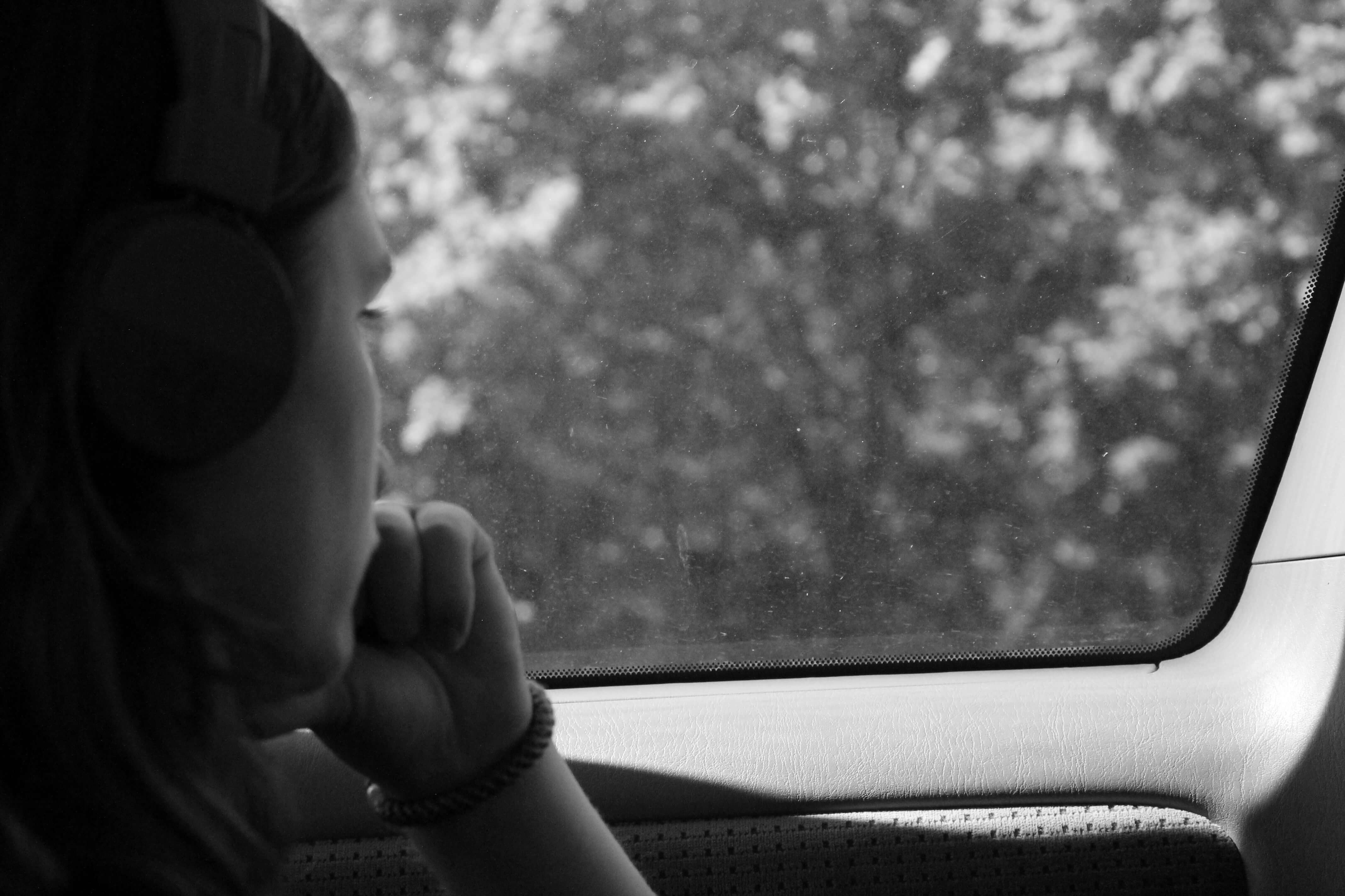 Image of a woman sitting in a car looking out the window thinking. If you are going through a major life change, work with a skilled therapist in life transition therapy in Austin, TX to help you adjust.