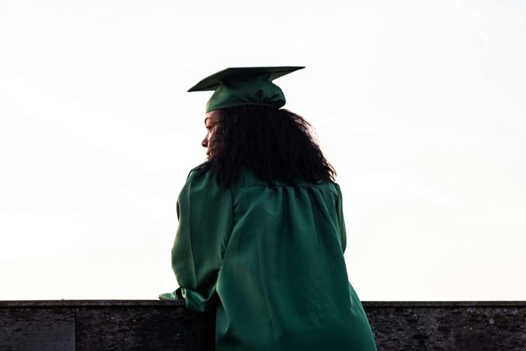 Image of a girl wearing a graduation cap and gown. If you are struggling to cope with a major life change, work with a skilled life transition therapist in Austin, TX to learn healthy coping skills.