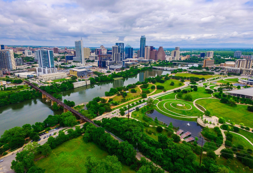 Image of the Austin, TX skyline over Butler park. If you are struggling to overcome a major life change, learn how to cope with life transitions with life transition therapy in Austin, TX.