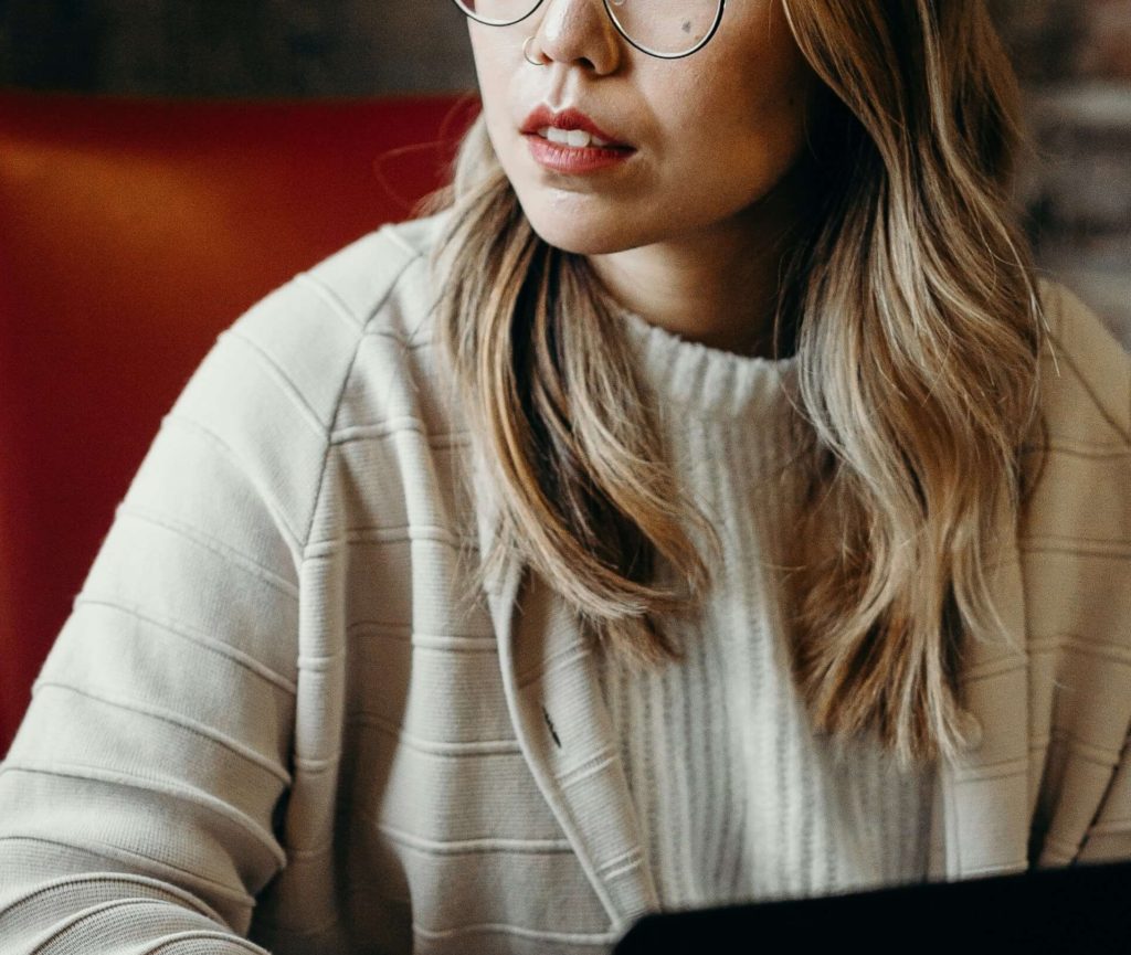 Image of a woman sitting down using a laptop. Cope with major life changes with the help of life transition therapy in Austin, TX.