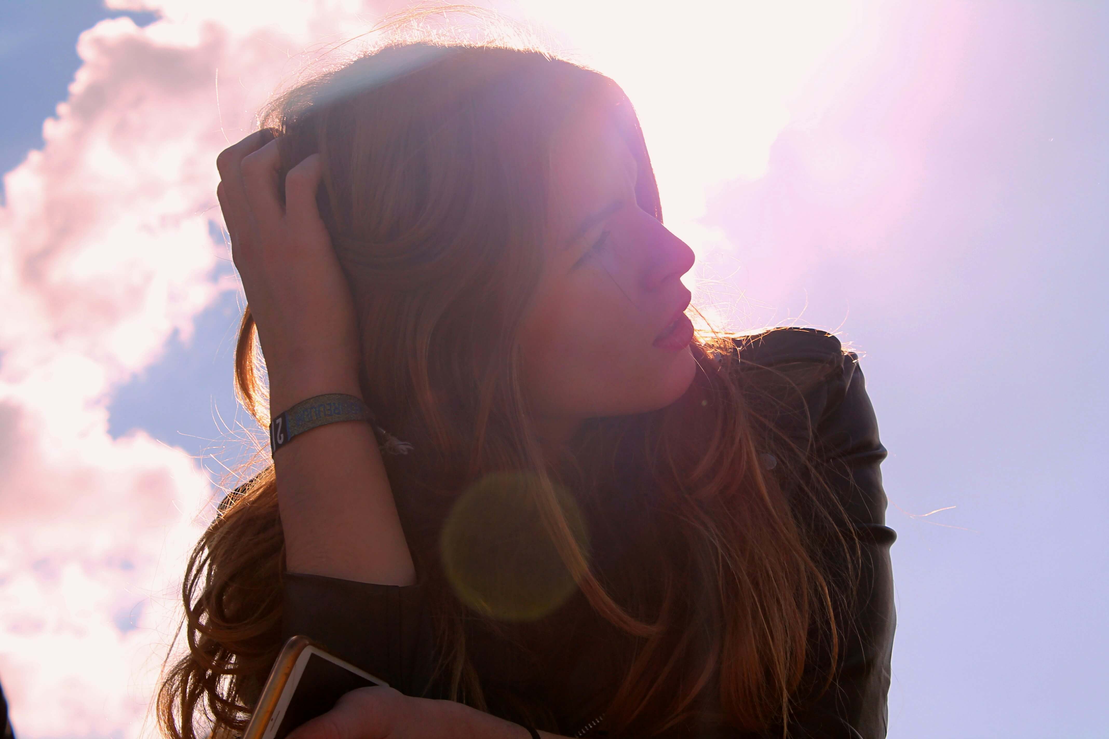 Image of a woman sitting outside on a sunny day. Work with a life transition therapist in Austin, TX to navigate major life challenges.